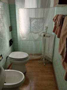 a bathroom with a toilet and a sink at Silenzio e Buio in Calizzano