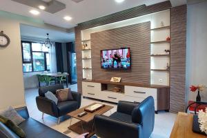 a living room with a flat screen tv on a wall at Black Sea Villa (Shekvetili-Kaprovani) in Shekvetili