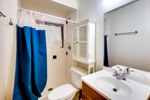 a bathroom with a white toilet and a sink at Historic Colorado Springs Home with Yard in Downtown in Colorado Springs +30 photos