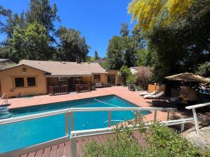 a swimming pool in front of a house at Villa La Reforma - Newly Designed 4BR HOUSE & POOL in Los Angeles by Topanga in Los Angeles