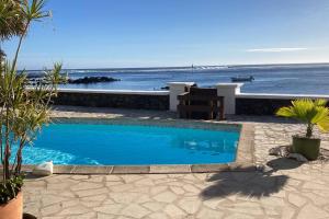 a swimming pool with a view of the ocean at La Case Chouchou in L'Étang-Salé les Bains