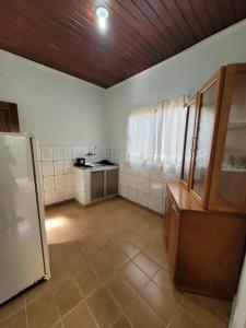 a large room with a kitchen with a refrigerator at Ingá Hospedagem in Porto Velho