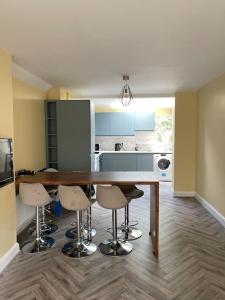 a kitchen with a table and chairs in a room at Heart of kinsale in Kinsale