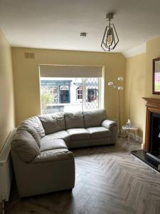 a living room with a couch and a fireplace at Heart of kinsale in Kinsale