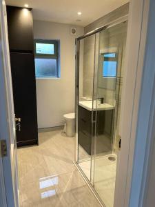 a bathroom with a glass shower and a toilet at Heart of kinsale in Kinsale