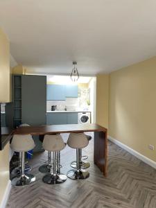 a kitchen with a table and stools in a room at Heart of kinsale in Kinsale