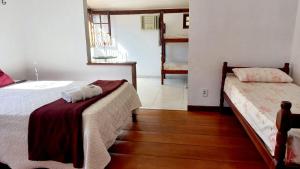 Postel nebo postele na pokoji v ubytování Villa dos Pássaros Paraty Hospedagem