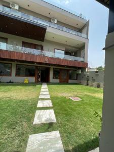 a large building with a lawn in front of it at Cyber Vista in Gurgaon