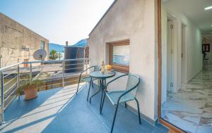 a balcony with a table and chairs on it at N&N in Risan