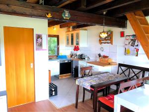 a kitchen with a table and a dining room at Ferienhaus, Schöntal-Winzenhofenn in Winzenhofen