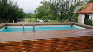 una piscina con terraza de madera y piscina en ZOĆEVIĆA KONAK, en Petrovići
