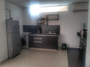 a small kitchen with a sink and a refrigerator at CASA EN GIRARDOT in Girardot