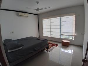 a bedroom with a bed and a large window at CASA EN GIRARDOT in Girardot