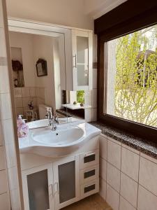 a bathroom with a sink and a large window at Ferienwohnung Landhaus in Zurow