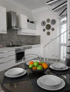 a kitchen with a bowl of fruit on a table at Townhouse Twenty in Żebbuġ