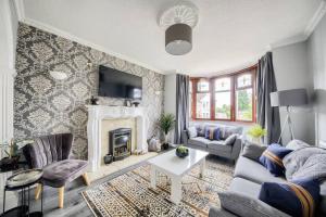 a living room with a couch and a fireplace at LOW RATE - Coventry for 3 BedRoom House with Garden, FREE Netflix and Unlimited Wi-fi - Driveway Parking - AGC in Coventry