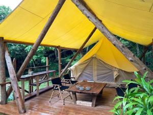 a large tent with a table and chairs on a deck at RAINBOW FOREST Permaculture filed - Vacation STAY 78984v in Ibaruma