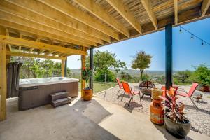 a patio with a tub and chairs and a table at Fredericksburg Retreat with Private Hot Tub and Patio! in Fredericksburg