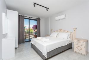 a white bedroom with a bed and a balcony at Villa Exclusive Paradise 1 in Dalyan +41 photos