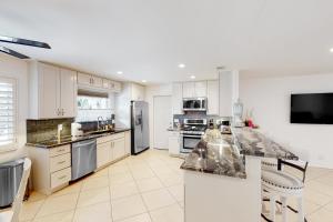 a large kitchen with white cabinets and appliances at Fred Waring Dreams in Palm Desert