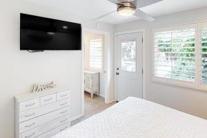 a bedroom with a bed and a tv on the wall at Fred Waring Dreams in Palm Desert