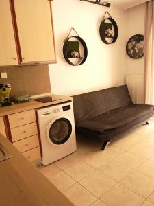 a laundry room with a washer and a sink at Serres Kavafi 7 city center , FREE PARKING , FREE NETFLIX in Serres