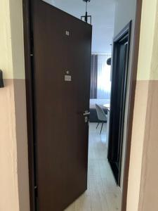a door leading to a room with a table at Lux Cotton in Podgorica