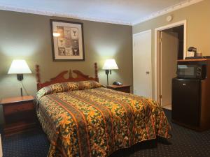 A bed or beds in a room at Western Village Inn