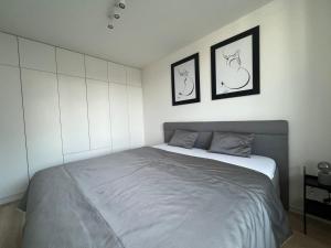 a bedroom with a bed with two pictures on the wall at Nová rezidencia, 7 minut pešo do centra in Košice