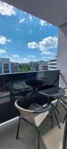 a balcony with chairs and tables and a view of a city at Nová rezidencia, 7 minut pešo do centra in Košice