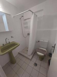 a bathroom with a green sink and a toilet at Alegria House 150m from the beach in Gouvia