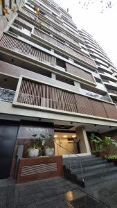 a large building with two potted plants in front of it at Studio ideal viaje en pareja o trabajo in San Miguel de Tucumán