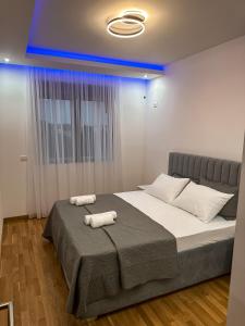 a bedroom with a bed with two towels on it at Enigma Apartment in Ulcinj