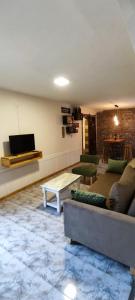 a living room with a couch and a table at Solaire Apart in Ciudad Lujan de Cuyo