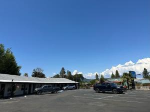 a parking lot with trucks parked in front of a building at Western Village Inn in Willits