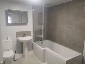 a bathroom with a sink and a tub and a toilet at John Street in Shildon