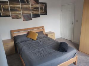 a bedroom with a bed with a yellow pillow at John Street in Shildon