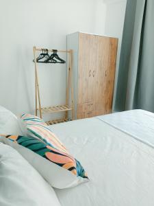a white bed with a pillow and a wooden cabinet at Ada suit in Kas