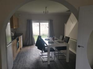 a kitchen with a table with chairs and a window at John Street in Shildon