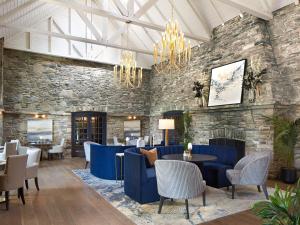 a lobby with blue furniture and a stone wall at The Glenerin Inn in Mississauga