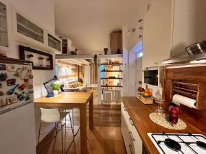 a kitchen with a table and a dining room at La casa dei sogni in Falconara Marittima