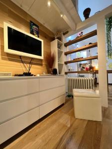 a living room with a flat screen tv on a wall at La casa dei sogni in Falconara Marittima
