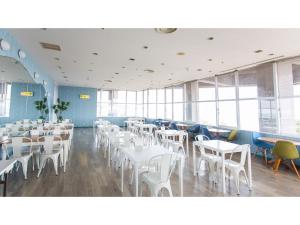 a dining room with white tables and chairs at Hotel AreaOne Sakaiminato Marina - Vacation STAY 81788v in Sakaiminato