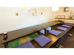 a row of tables in a room with purple mats at Hotel AreaOne Sakaiminato Marina - Vacation STAY 81788v in Sakaiminato