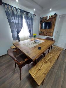Etno House Jakic في باغينا باستا: طاولة خشبية في غرفة معيشة مع نافذة