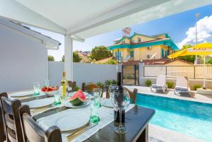 a dining table with a view of a swimming pool at Villa Exclusive Paradise 2 in Dalyan