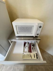 a microwave oven sitting on top of a shelf at AYAMARUDO-MU - Vacation STAY 32625v in Amami