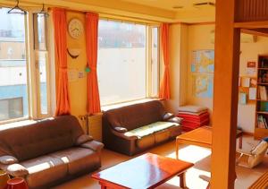 a living room with two leather couches and a window at Kamome Building 3F - Vacation STAY 54301v in Otaru