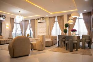 Una sala de estar con un sofá, una mesa y sillas. en Vanity Villa Waterfront Residence Ikoyi, en Lagos