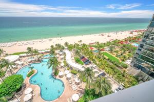 an aerial view of a resort with a beach at TRUMP INTL 2 BEDROOM APARTMENT 1600 Sqf OCEAN FRONT in Miami Beach